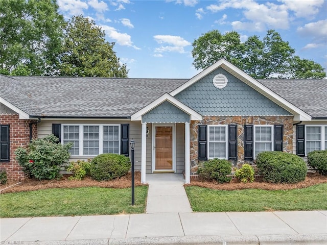 711 Sunset Ave Unit B, Asheboro, NC 27203 - view of front of house with stone siding, roof with shingles, and a front lawn
