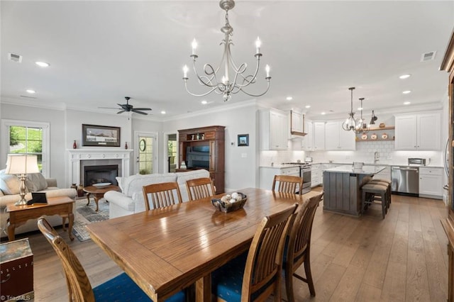 1623 Angus Ridge Dr, Kernersville, NC 27284 - dining room with a chandelier, ceiling fan, crown molding, a fireplace, and recessed lighting