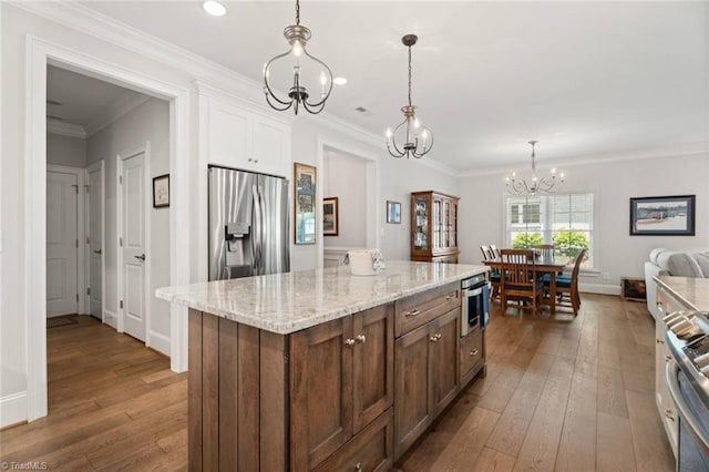 1623 Angus Ridge Dr, Kernersville, NC 27284 - kitchen featuring stainless steel appliances, a chandelier, dark wood-type flooring, hanging light fixtures, and white cabinetry
