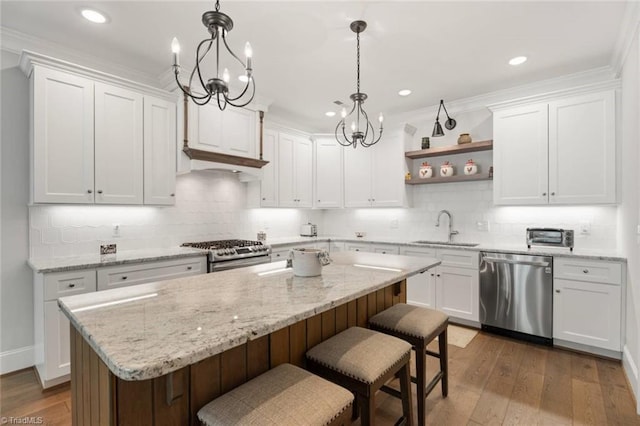1623 Angus Ridge Dr, Kernersville, NC 27284 - kitchen with appliances with stainless steel finishes, open shelves, white cabinetry, a center island, and recessed lighting