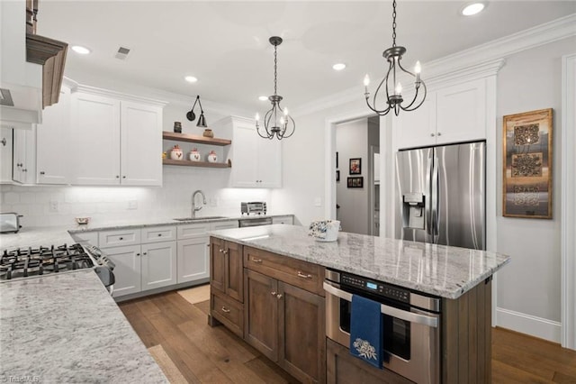 1623 Angus Ridge Dr, Kernersville, NC 27284 - kitchen with appliances with stainless steel finishes, white cabinets, decorative backsplash, recessed lighting, and crown molding