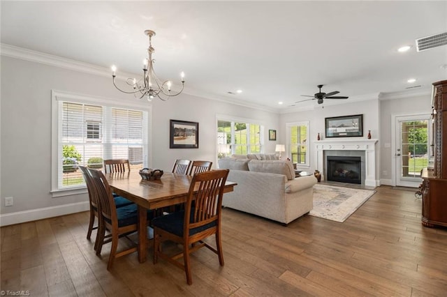 1623 Angus Ridge Dr, Kernersville, NC 27284 - dining room featuring wood-type flooring, a chandelier, recessed lighting, crown molding, and a fireplace