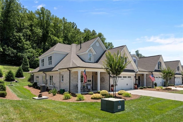 1623 Angus Ridge Dr, Kernersville, NC 27284 - view of front facade featuring concrete driveway, a front yard, a porch, a garage, and brick siding