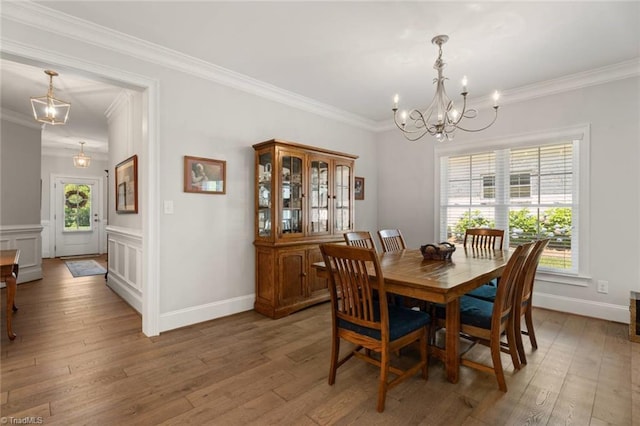 1623 Angus Ridge Dr, Kernersville, NC 27284 - dining room with a chandelier, ornamental molding, and light wood-type flooring