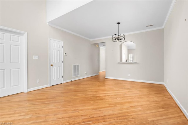 interior space featuring light wood-type flooring, an inviting chandelier, and ornamental molding