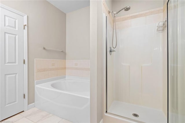 bathroom featuring tile patterned floors and a tile shower