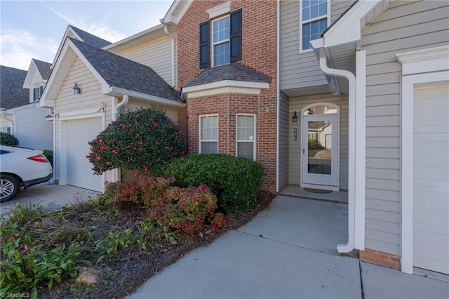 doorway to property with a garage