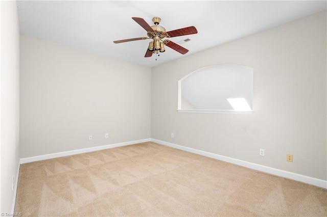 carpeted spare room featuring ceiling fan