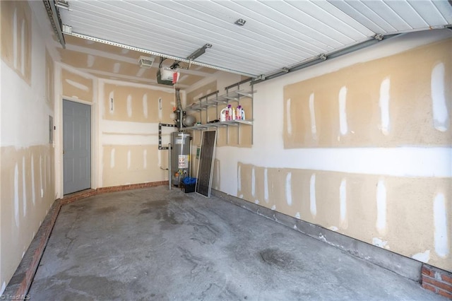 garage featuring gas water heater and a garage door opener