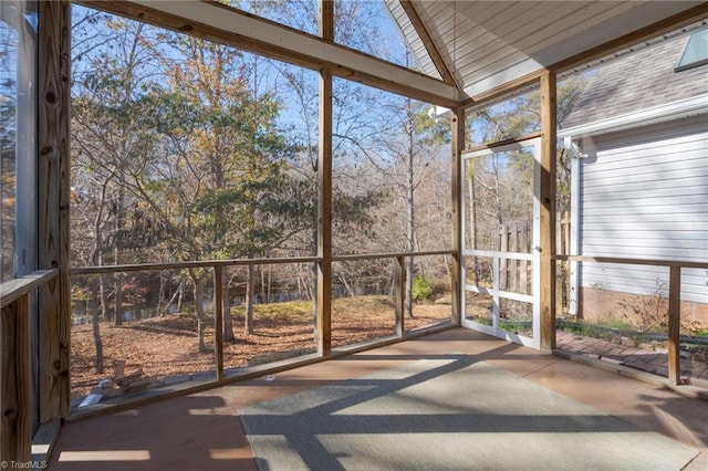 unfurnished sunroom with vaulted ceiling