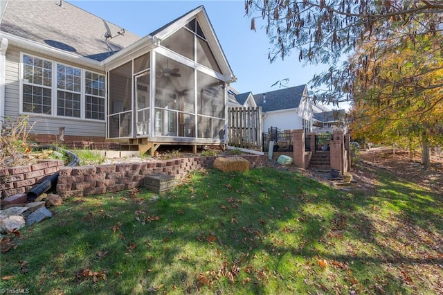 back of house featuring a sunroom and a yard