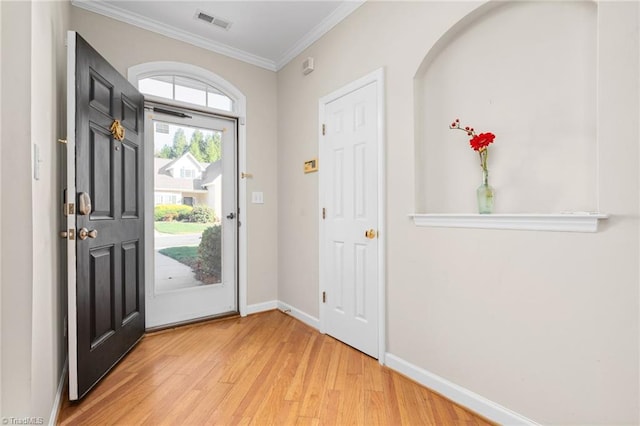 entrance foyer with hardwood / wood-style floors and ornamental molding