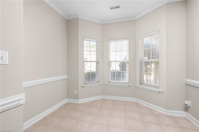 unfurnished room featuring light tile patterned flooring and crown molding