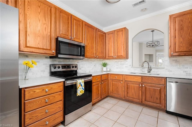 kitchen featuring stainless steel appliances, sink, tasteful backsplash, light tile patterned floors, and ornamental molding