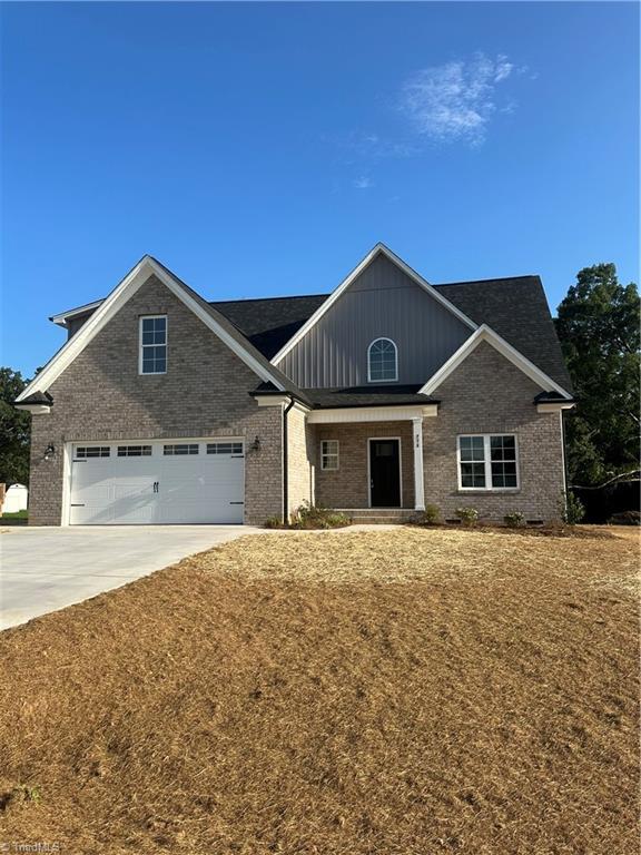 craftsman-style home with a garage and a front lawn