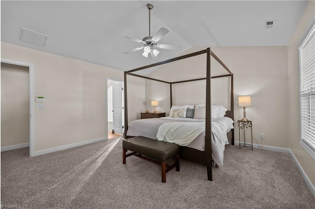 carpeted bedroom with ceiling fan and vaulted ceiling