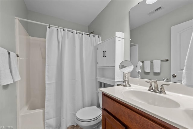 full bathroom featuring shower / bath combo, vanity, and toilet