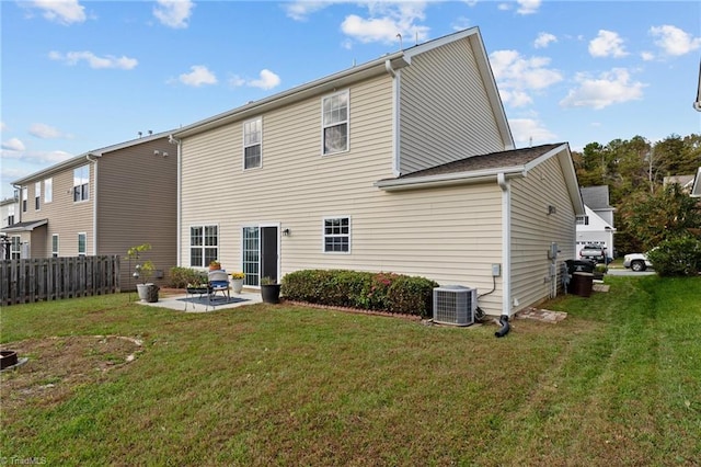 back of house with central AC unit, a patio area, and a lawn