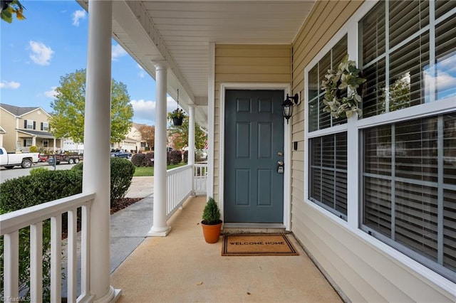 view of exterior entry with covered porch