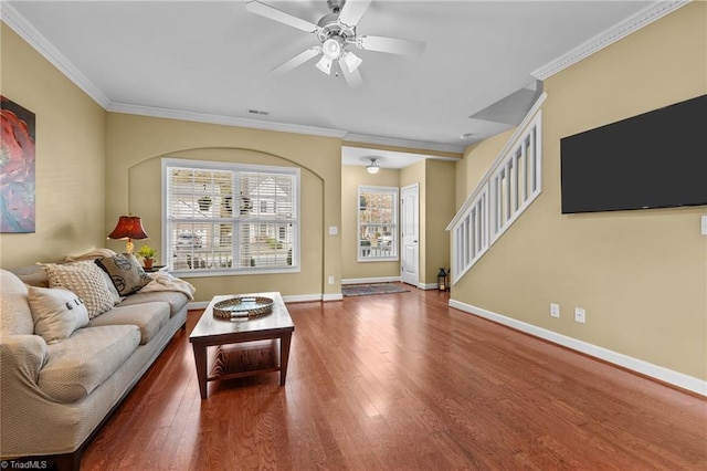 living room with hardwood / wood-style flooring, ceiling fan, and ornamental molding