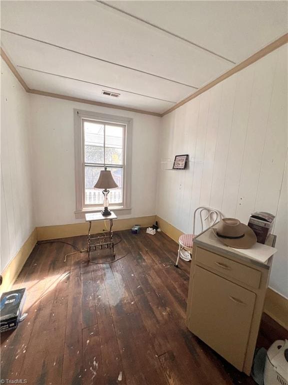 interior space featuring wood walls and dark hardwood / wood-style flooring