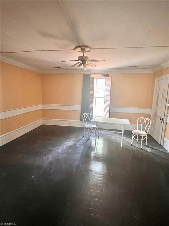 spare room featuring ceiling fan and crown molding