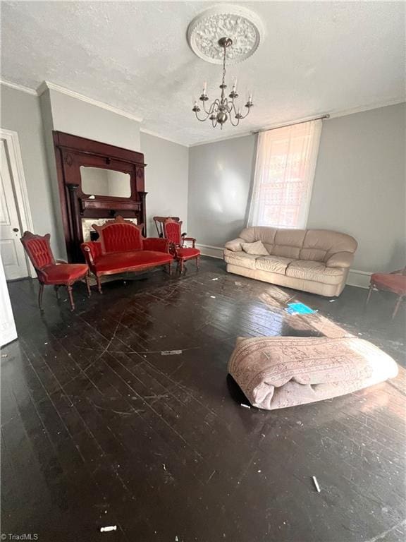 living room with ornamental molding, wood-type flooring, and a chandelier