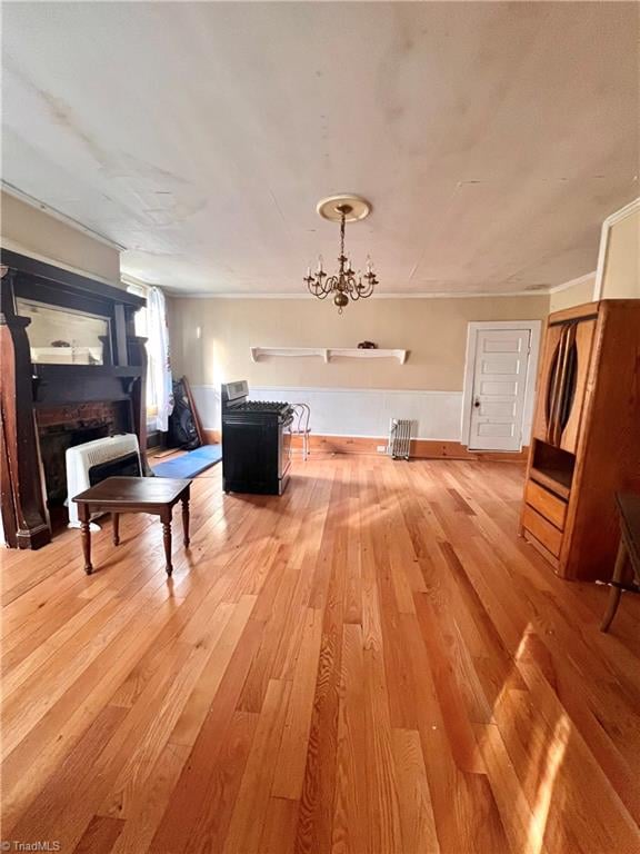 miscellaneous room with hardwood / wood-style floors and a notable chandelier