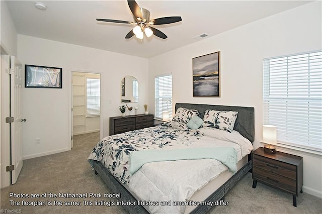 carpeted bedroom featuring baseboards, a ceiling fan, and visible vents