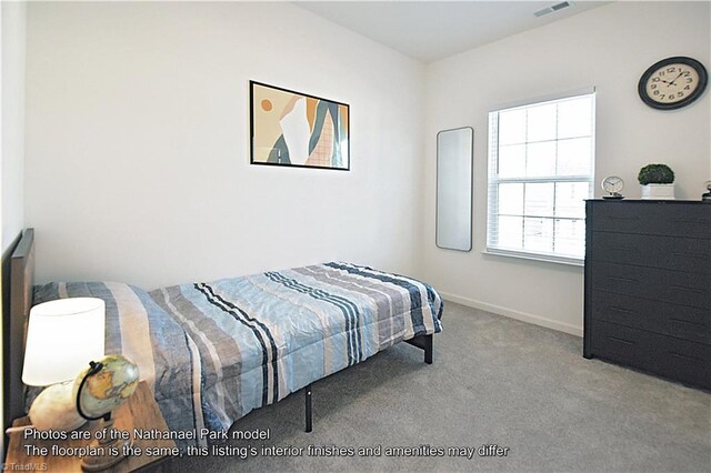 carpeted bedroom featuring baseboards and visible vents