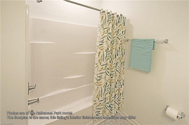 bathroom with shower / bath combo with shower curtain and baseboards