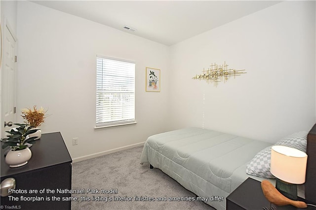 carpeted bedroom featuring baseboards and visible vents