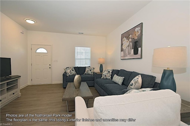 living room with baseboards, wood finished floors, and visible vents