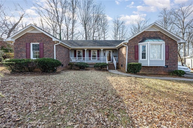 single story home with a porch and a front lawn