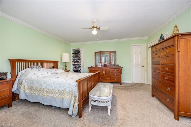 carpeted bedroom featuring ornamental molding and ceiling fan