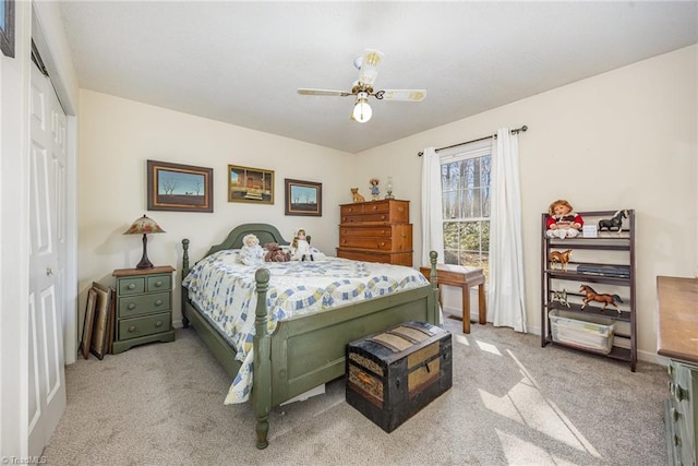 carpeted bedroom featuring ceiling fan and a closet