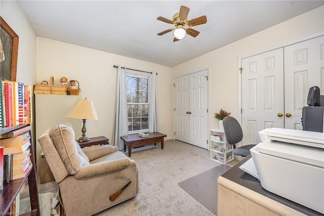 carpeted office featuring ceiling fan