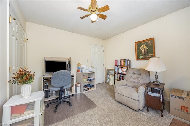 carpeted home office with ceiling fan