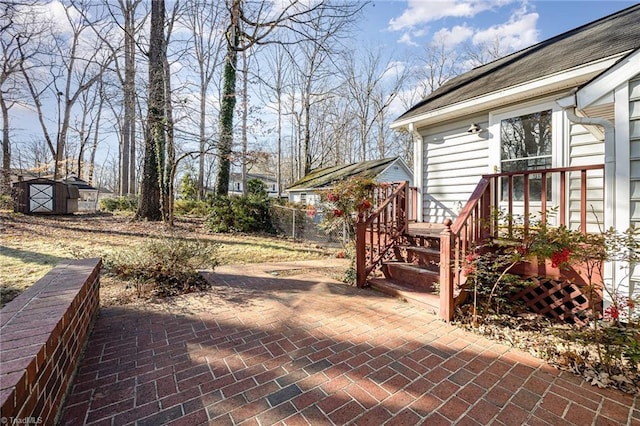 view of patio featuring a shed