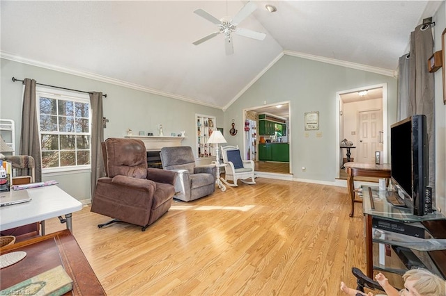 living room featuring ornamental molding, lofted ceiling, ceiling fan, and light hardwood / wood-style flooring