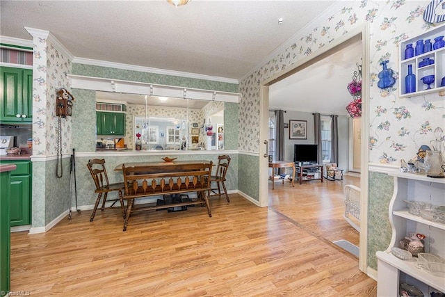 dining room with ornamental molding and light wood-type flooring