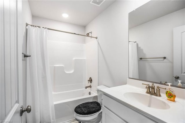 full bathroom with vanity, shower / tub combo, and toilet