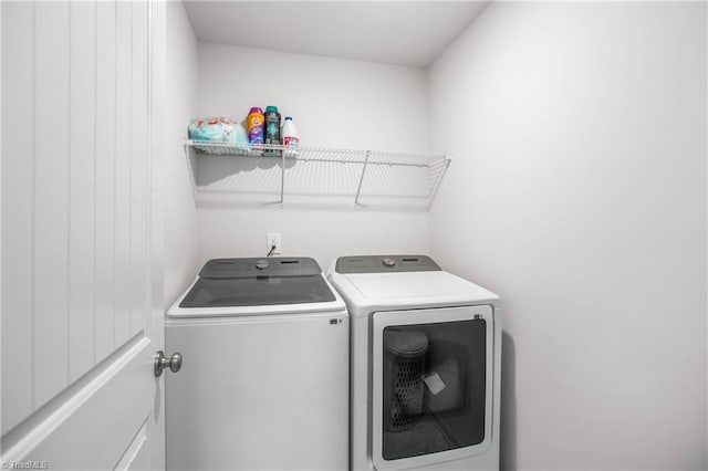 clothes washing area with washing machine and dryer