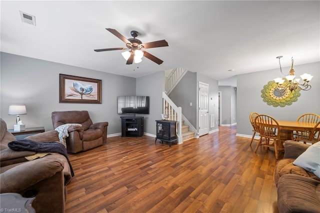 living room with wood-type flooring and ceiling fan with notable chandelier