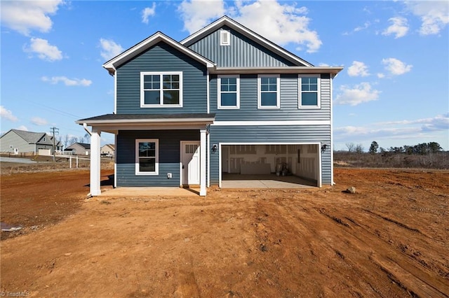 rear view of house featuring a garage