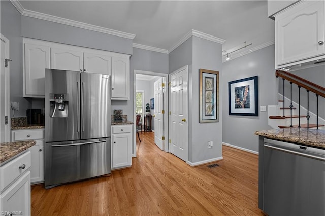 1005 Stuart Dr, Mebane, NC 27302 - kitchen with light wood-style floors, dark stone counters, white cabinets, and stainless steel appliances
