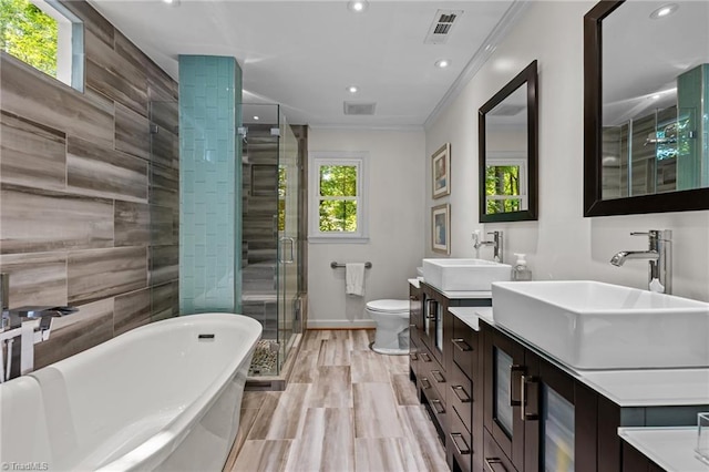 1005 Stuart Dr, Mebane, NC 27302 - bathroom with a soaking tub, visible vents, a shower stall, and a sink