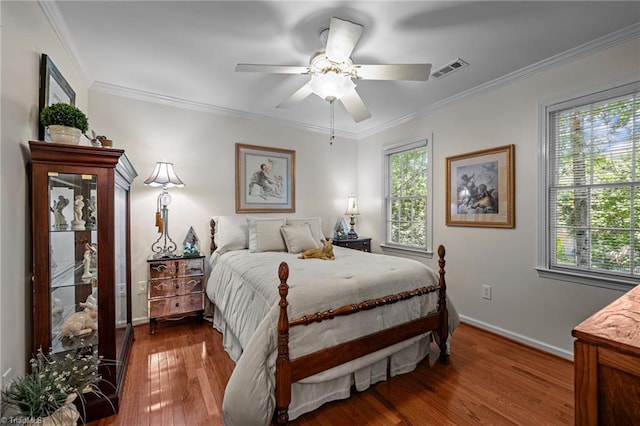 1005 Stuart Dr, Mebane, NC 27302 - bedroom with crown molding, ceiling fan, baseboards, wood finished floors, and visible vents