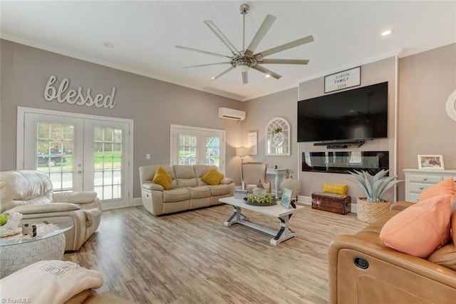 living room with french doors, ornamental molding, hardwood / wood-style floors, a wall unit AC, and ceiling fan