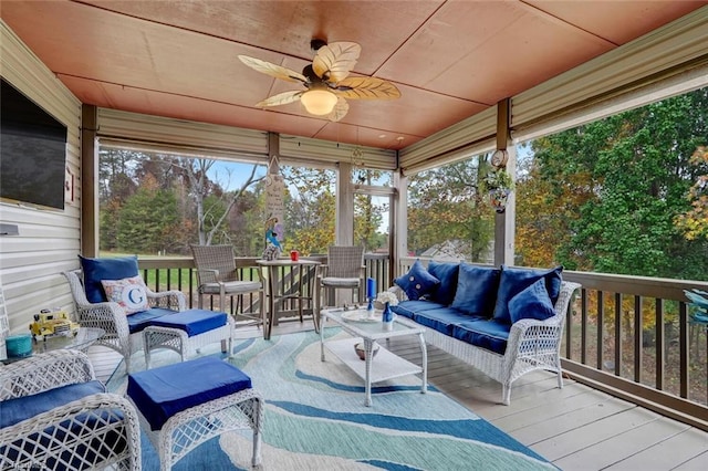 sunroom / solarium with a healthy amount of sunlight and ceiling fan